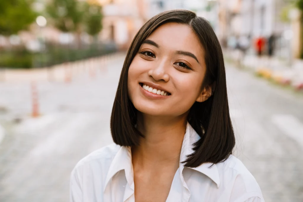 A young woman with a radiant smile, possibly interested in Chipped Tooth Repair at Laughlin Dental